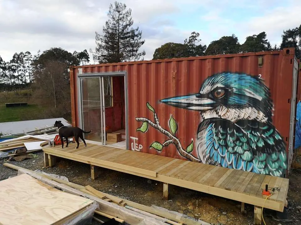 Shipping container home with a mural and a newly built timber deck