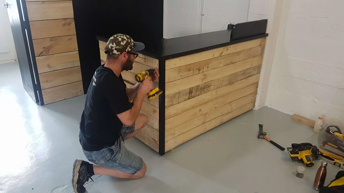 Dan fitting a timber-clad service counter inside a commercial fit-out