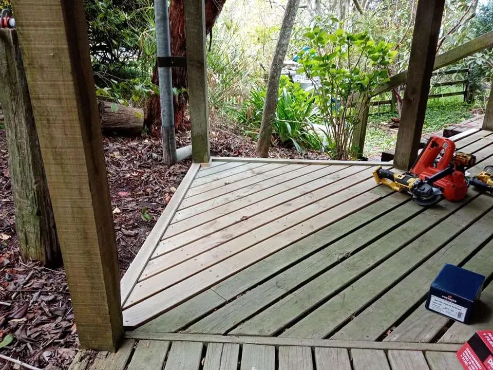 Timber deck part built with tools laid out across the boards