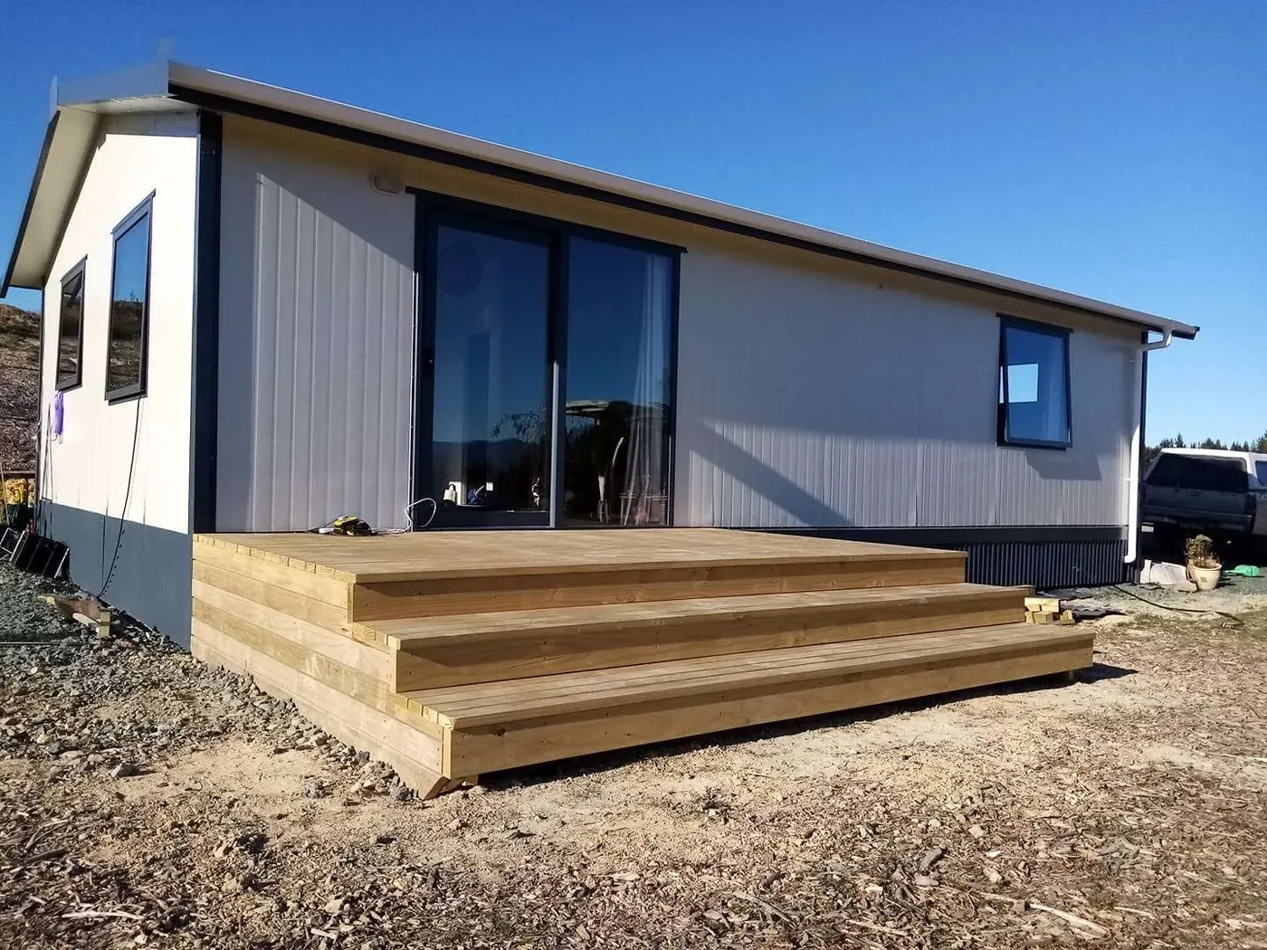 New timber deck and steps built onto a modern Tasman home