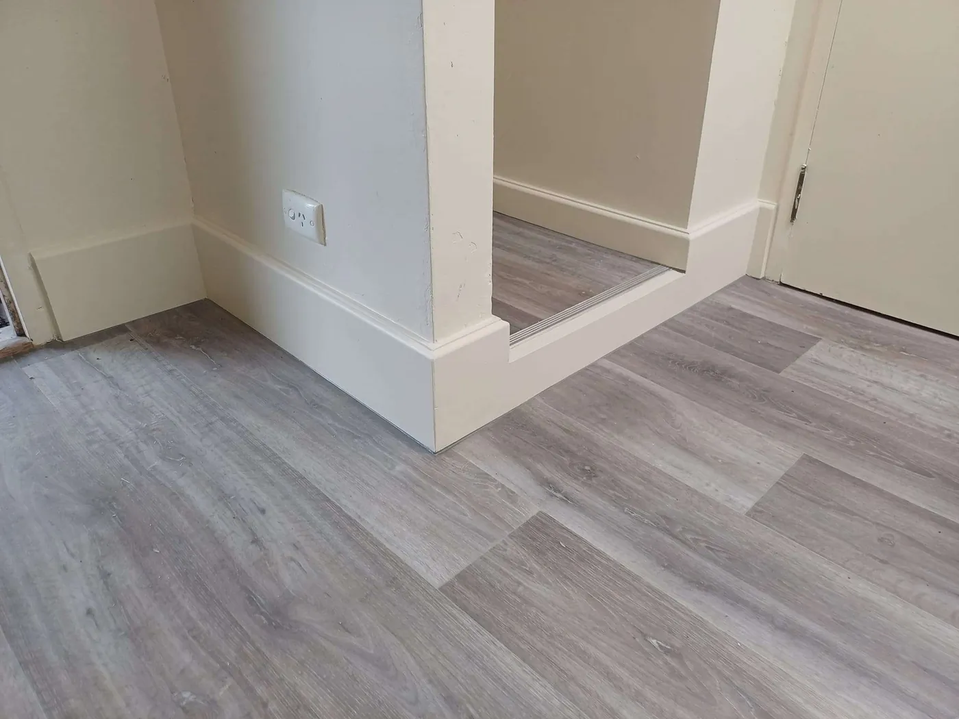 New skirting and timber-look flooring in a freshly finished room