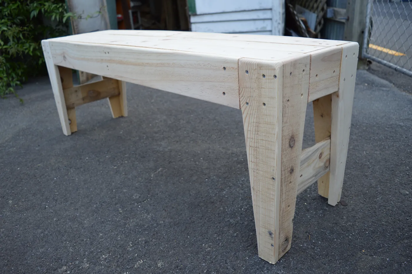 Pale timber outdoor table freshly built on a driveway